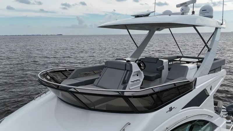 Slide: The Image of 2021 Cruisers Yachts 60 Cantius Flybridge on open water, showcasing sleek design and luxury features. - 46