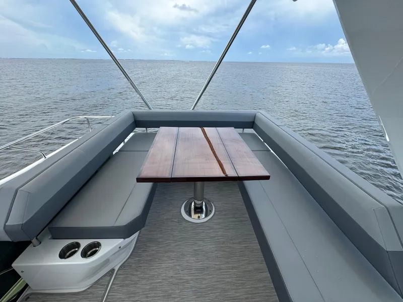 Slide: The Image of 2021 Cruisers Yachts 60 Cantius Flybridge, elegant seating area with ocean view. - 49