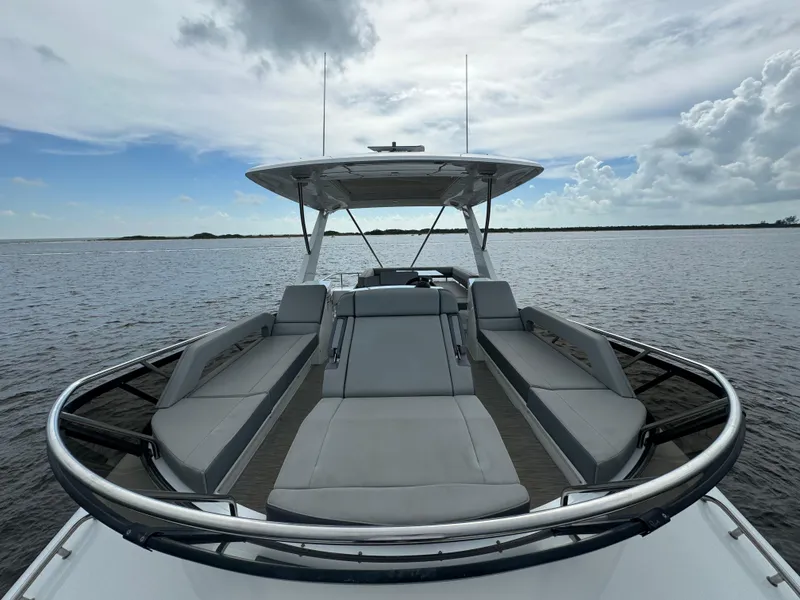 Slide: The Image of 2021 Cruisers Yachts 60 Cantius Flybridge on open water, showcasing sleek design and luxury seating. - 51