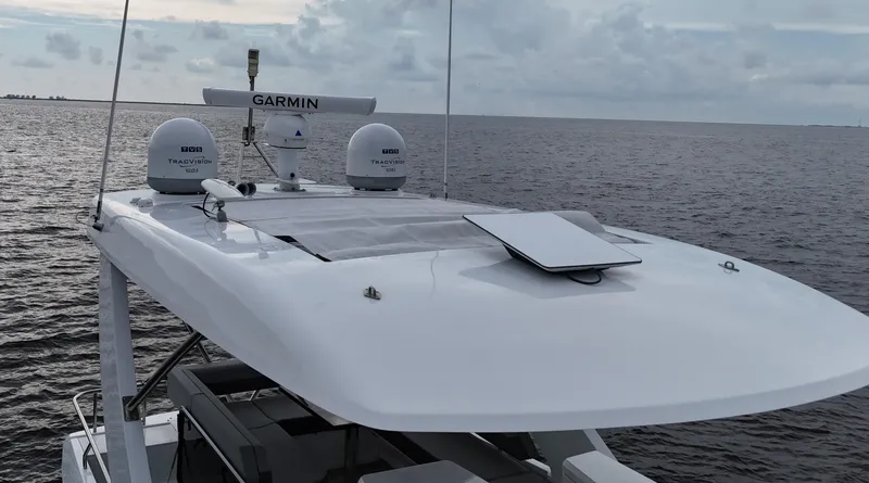 Slide: The Image of 2021 Cruisers Yachts 60 Cantius Flybridge on open water, featuring advanced Garmin navigation. - 12