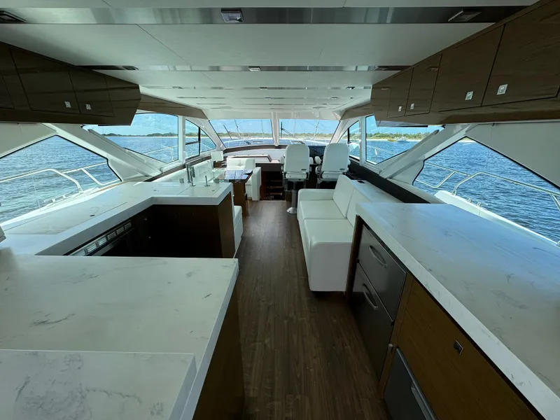 Slide: The Image of Luxurious interior of 2021 Cruisers Yachts 60 Cantius Flybridge with modern kitchen and seating. - 14