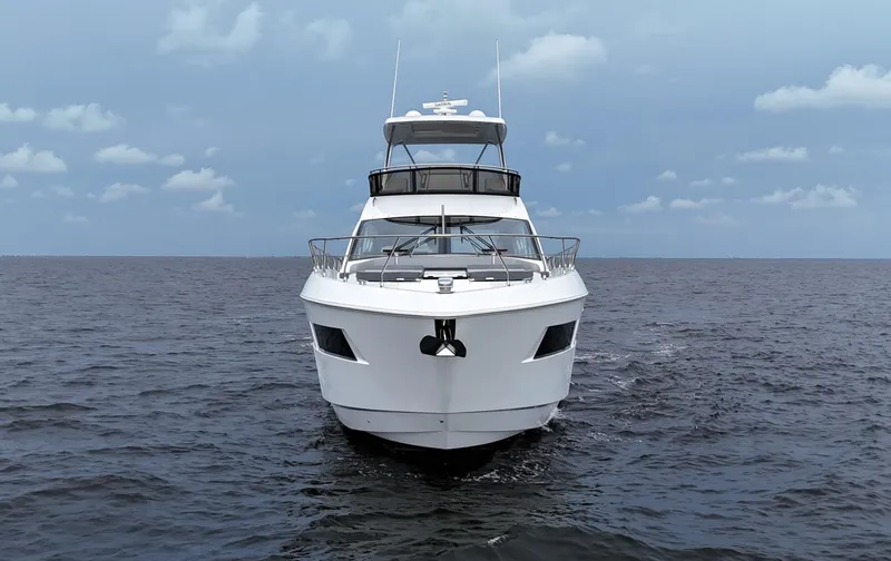 Slide: The Image of 2021 Cruisers Yachts 60 Cantius Flybridge on open sea, front view. - 3