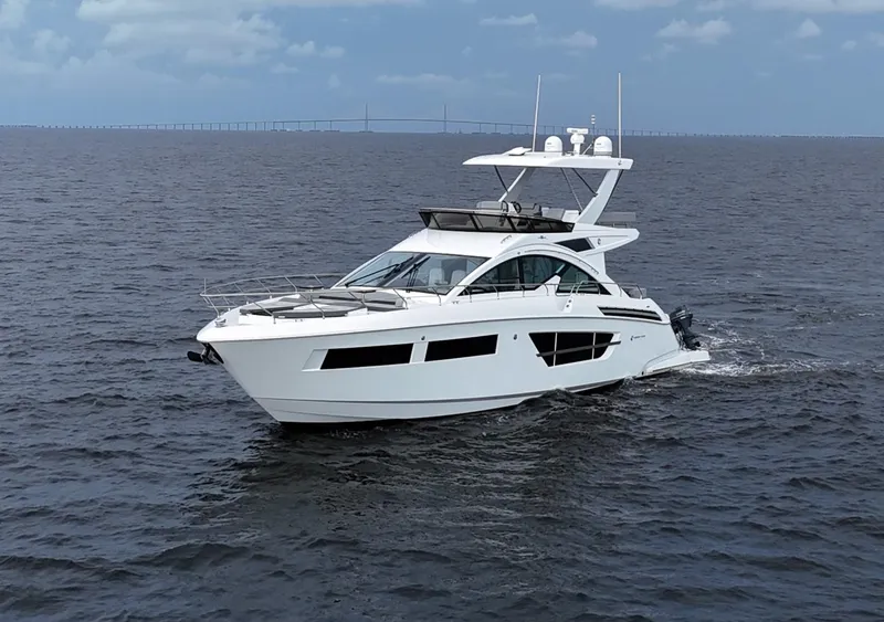 Slide: The Image of 2021 Cruisers Yachts 60 Cantius Flybridge cruising on open water. - 4