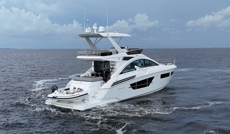 Slide: The Image of 2021 Cruisers Yachts 60 Cantius Flybridge cruising on open water. - 6