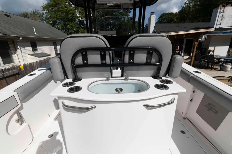 Slide: The Image of 2020 Sea Pro 259 Center Console boat interior with seating and cup holders. - 10