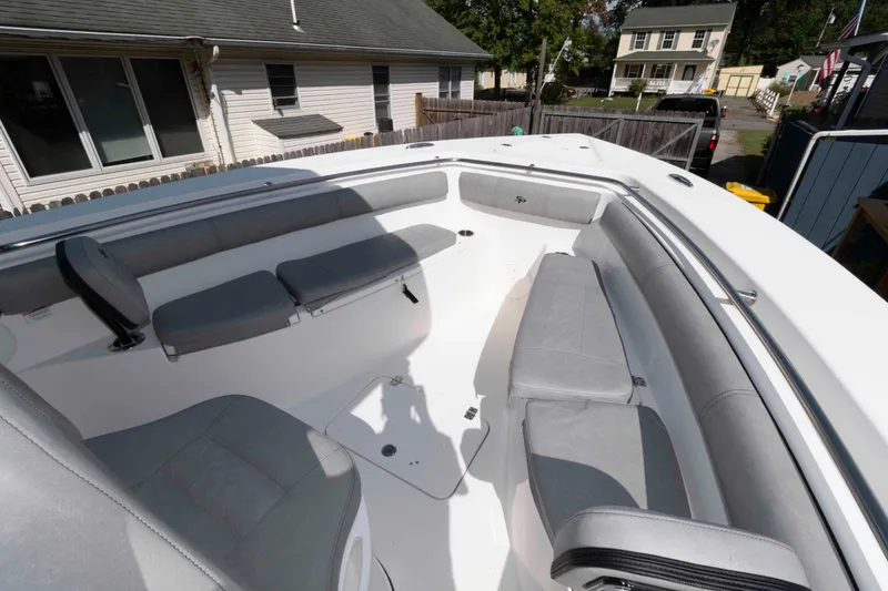 Slide: The Image of 2020 Sea Pro 259 Center Console boat with spacious seating in residential driveway. - 11