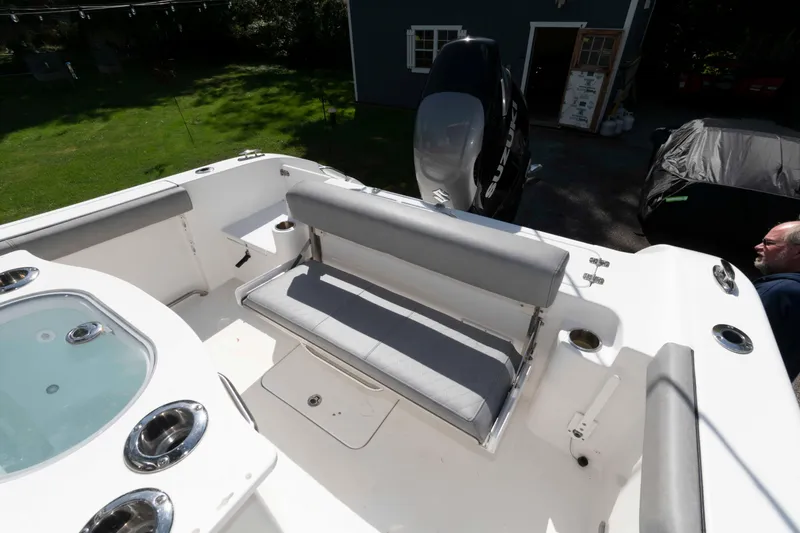 Slide: The Image of 2020 Sea Pro 259 Center Console boat interior with seating and engine view. - 14