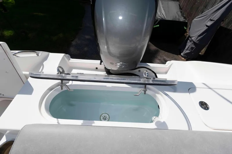 Slide: The Image of 2020 Sea Pro 259 Center Console boat with open livewell and outboard motor. - 17