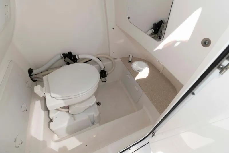 Slide: The Image of 2020 Sea Pro 259 Center Console boat bathroom with toilet and sink. - 21