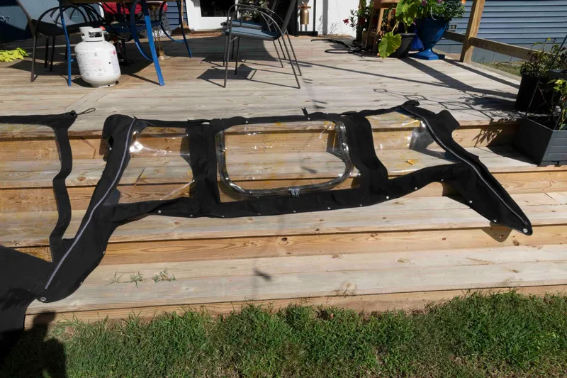 Slide: The Image of Clear boat enclosure on wooden deck, compatible with 2020 Sea Pro 259 Center Console. - 23