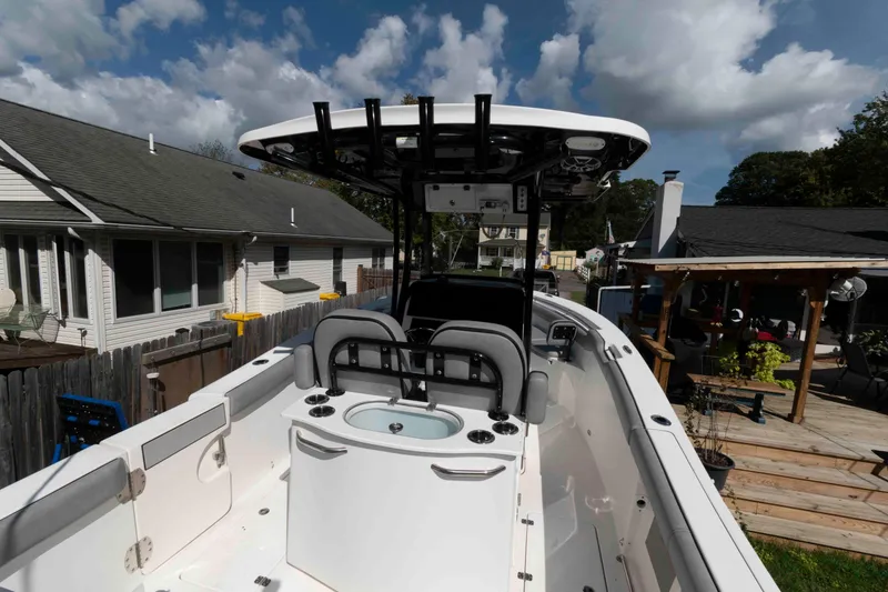 Slide: The Image of 2020 Sea Pro 259 Center Console boat in residential backyard, under a partly cloudy sky. - 4