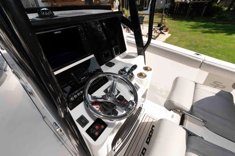 Slide: The Image of 2020 Sea Pro 259 Center Console boat interior with steering wheel and controls. - 8