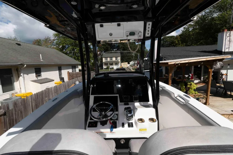 Slide: The Image of 2020 Sea Pro 259 Center Console boat interior with steering wheel and control panel. - 9