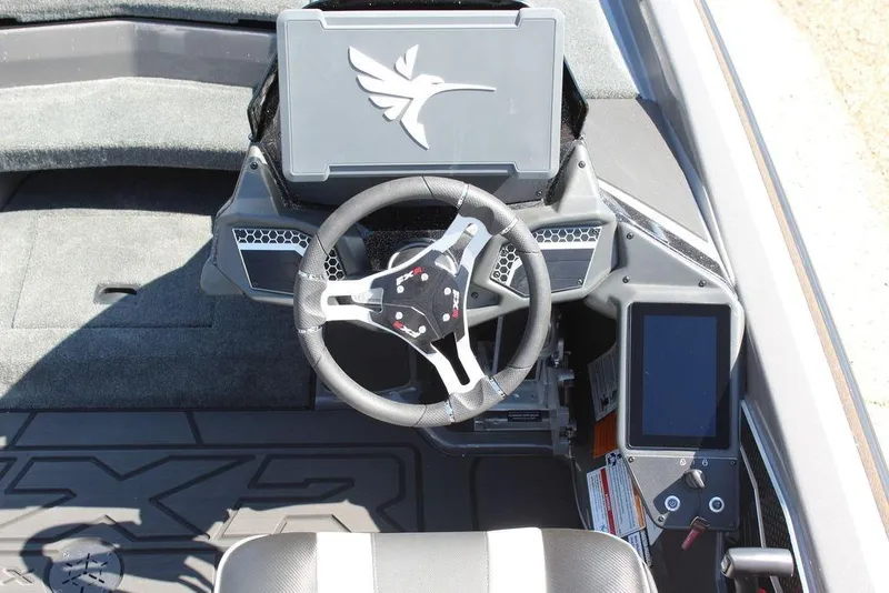 Slide: The Image of 2026 Skeeter FXR21 FLEX boat cockpit with modern steering wheel and digital controls. - 14
