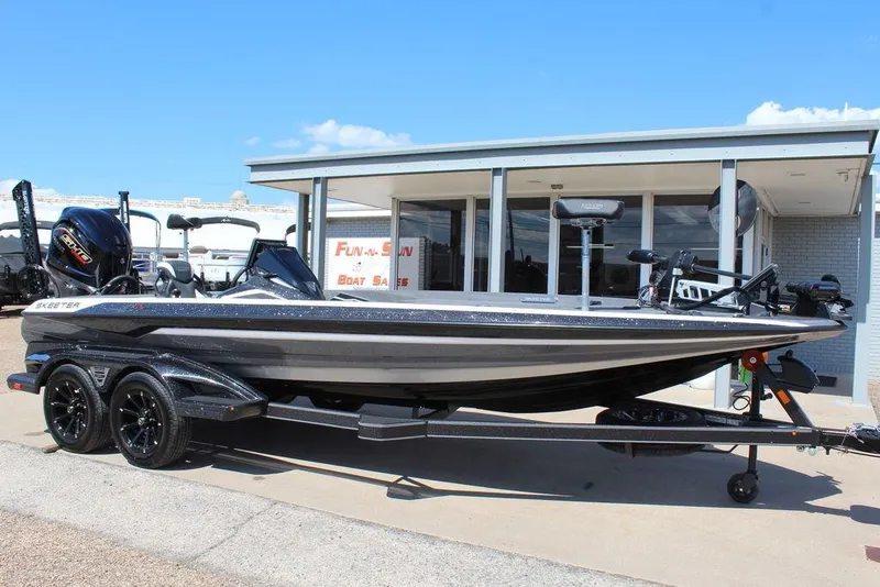 Slide: The Image of 2026 Skeeter FXR21 FLEX boat on trailer, parked outside dealership. - 4