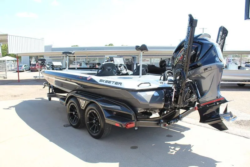 Slide: The Image of 2026 Skeeter FXR21 FLEX boat on trailer, rear view, in outdoor setting. - 5