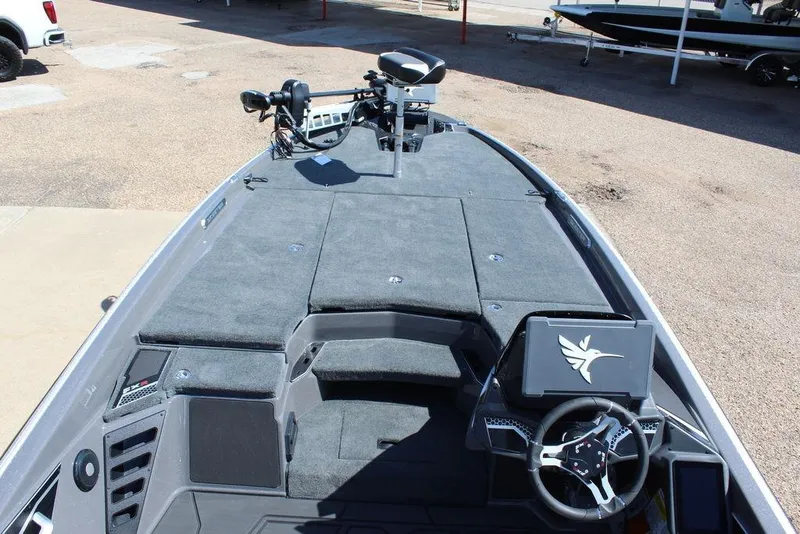 Slide: The Image of 2026 Skeeter FXR21 FLEX boat interior with steering wheel and control panel. - 9