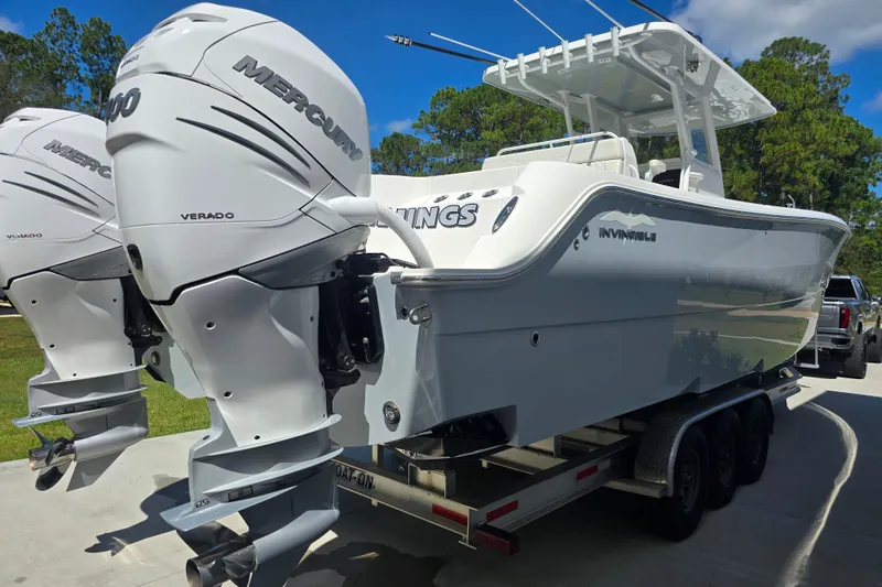 Slide: The Image of 2022 Invincible 33 Catamaran with twin Mercury Verado engines on a trailer. - 14