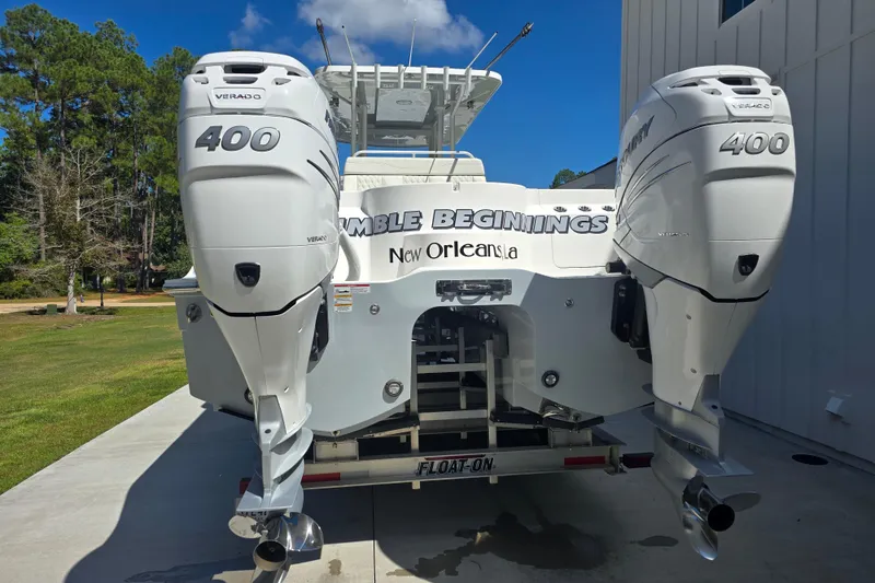 Slide: The Image of 2022 Invincible 33 Catamaran with twin 400 Verado engines, parked outdoors. - 15