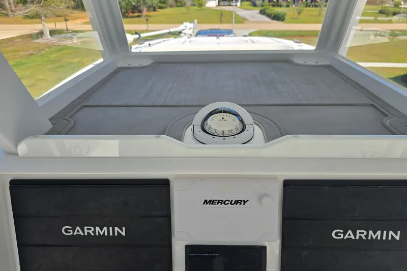 Slide: The Image of 2022 Invincible 33 Catamaran dashboard with Garmin displays and Mercury controls. - 21