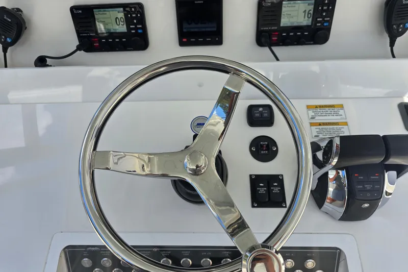 Slide: The Image of Steering wheel and controls of 2022 Invincible 33 Catamaran boat cockpit. - 22