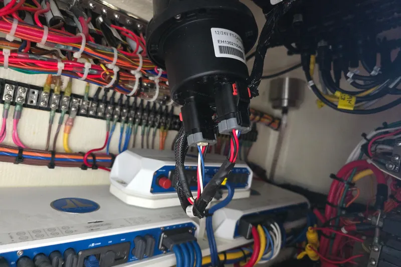 Slide: The Image of Electrical wiring and components inside a 2022 Invincible 33 Catamaran boat. - 25