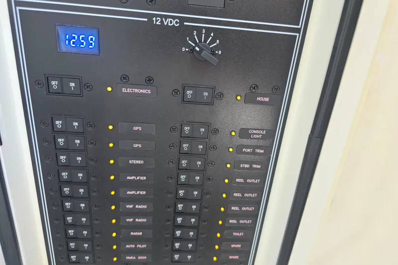 Slide: The Image of Control panel of 2022 Invincible 33 Catamaran with various electronic switches and indicators. - 27
