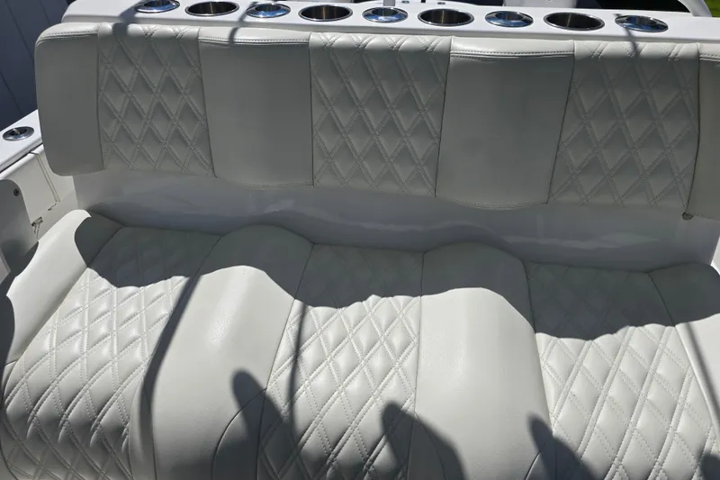Slide: The Image of Luxurious seating on 2022 Invincible 33 Catamaran with diamond-stitched upholstery and cup holders. - 29