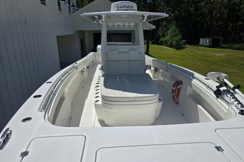 Slide: The Image of 2022 Invincible 33 Catamaran with Garmin system, sleek white deck, and comfortable seating. - 35