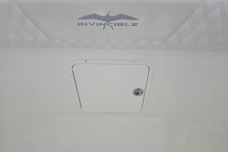 Slide: The Image of 2022 Invincible 33 Catamaran interior detail with logo and storage compartment. - 41