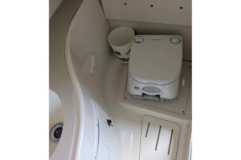 Slide: The Image of 2001 Pursuit 2870 Walkaround boat interior with compact marine toilet. - 15