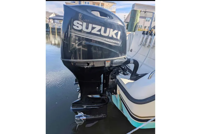 Slide: The Image of Outboard motor on a 2001 Pursuit 2870 Walkaround boat, docked in a marina. - 16