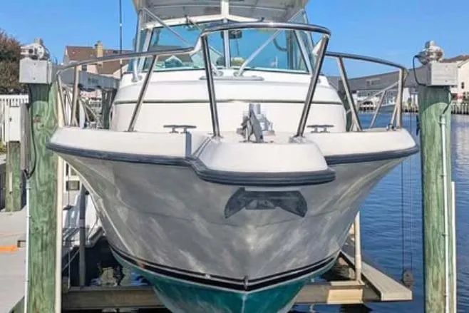 Slide: The Image of 2001 Pursuit 2870 Walkaround boat docked at marina, front view. - 17