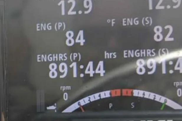 Slide: The Image of Digital display showing engine hours and temperature for 2001 Pursuit 2870 Walkaround boat. - 21