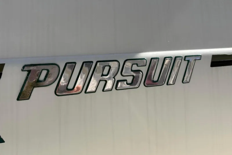 Slide: The Image of 2001 Pursuit 2870 Walkaround boat logo on white surface. - 22