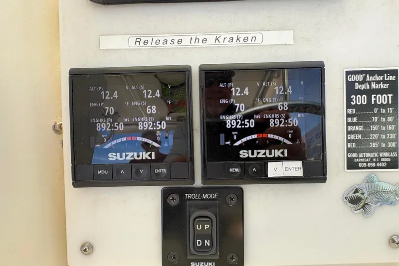 Slide: The Image of Control panel of a 2001 Pursuit 2870 Walkaround boat with Suzuki engine displays. - 30