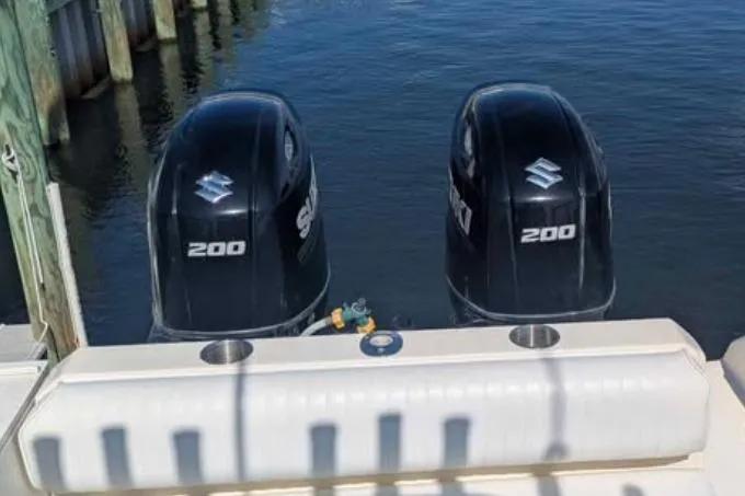 Slide: The Image of Twin Suzuki 200 outboard motors on a 2001 Pursuit 2870 Walkaround boat. - 38