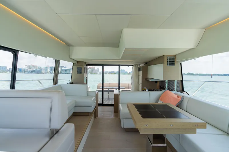 Slide: The Image of Interior of 2019 Prestige 520 Flybridge yacht with modern seating and panoramic windows. - 12