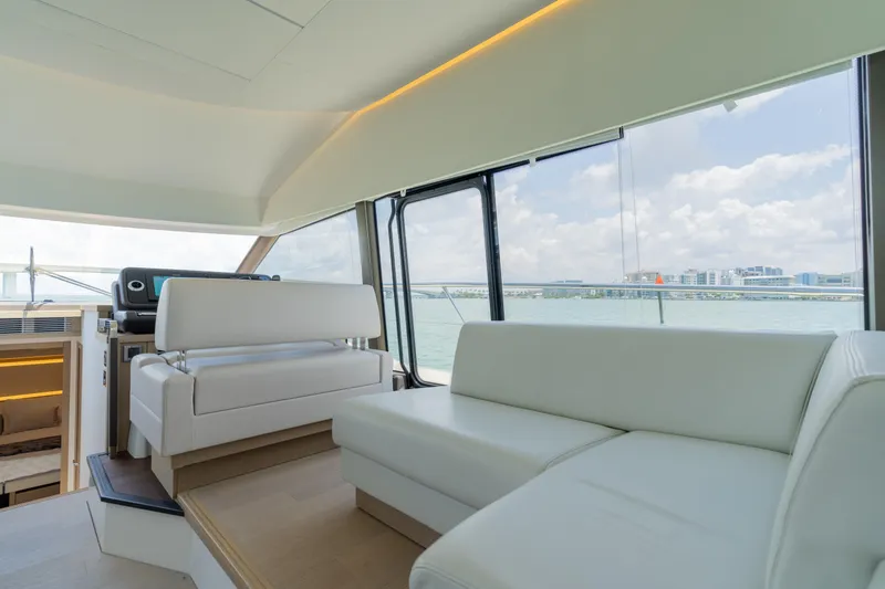Slide: The Image of Interior of 2019 Prestige 520 Flybridge yacht with modern seating and panoramic windows. - 13