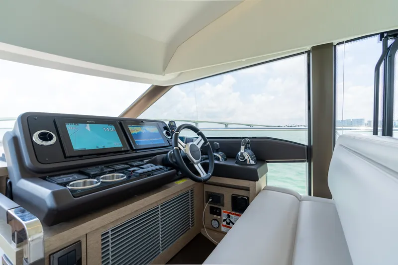 Slide: The Image of 2019 Prestige 520 Flybridge yacht helm station with modern navigation system and comfortable seating. - 17