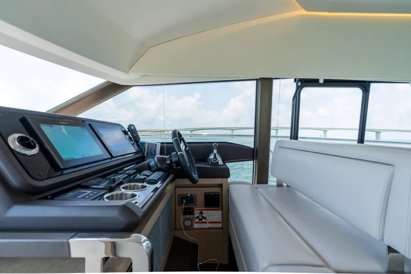 Slide: The Image of Prestige 520 Flybridge 2019 yacht helm station with modern navigation equipment and panoramic view. - 18