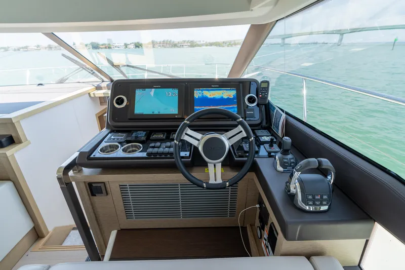 Slide: The Image of Interior helm of 2019 Prestige 520 Flybridge yacht with modern controls and seating. - 19