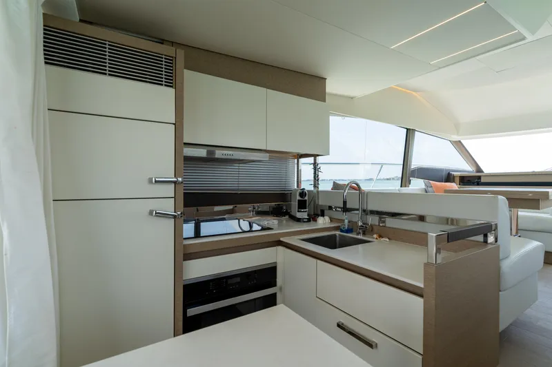 Slide: The Image of Prestige 520 Flybridge 2019 yacht helm station with navigation screens and controls. - 20