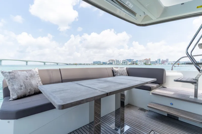 Slide: The Image of 2019 Prestige 520 Flybridge yacht with sun loungers on deck. - 26