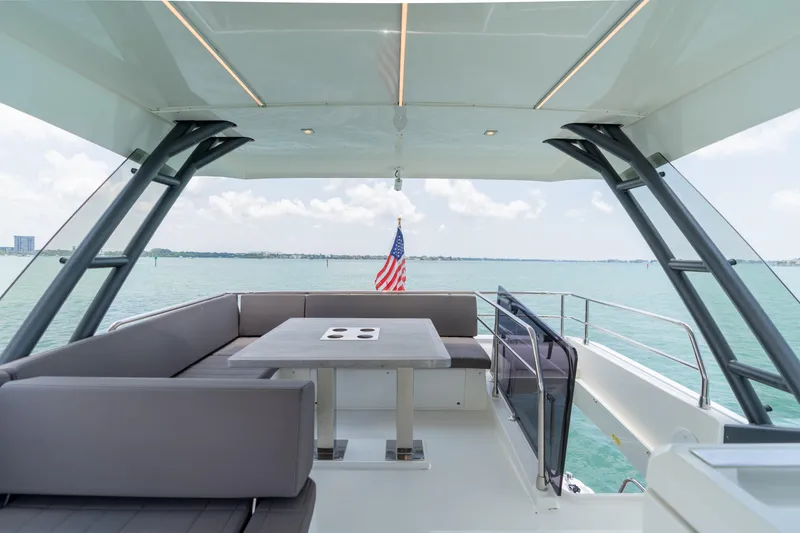 Slide: The Image of Prestige 520 Flybridge 2019 yacht interior with ocean view and bridge in the background. - 36