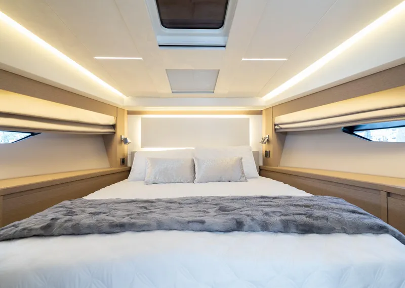 Slide: The Image of Luxurious bedroom interior of 2019 Prestige 520 Flybridge yacht with modern decor and flat-screen TV. - 9