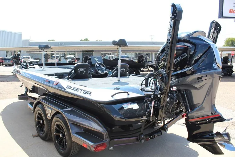 Slide: The Image of 2026 Skeeter FXR21 FLEX boat with Yamaha engine, parked outdoors. - 10