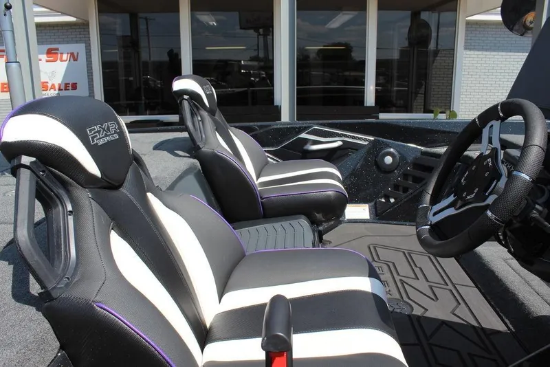 Slide: The Image of 2026 Skeeter FXR21 FLEX boat interior with sleek black and white seats and modern steering wheel. - 17