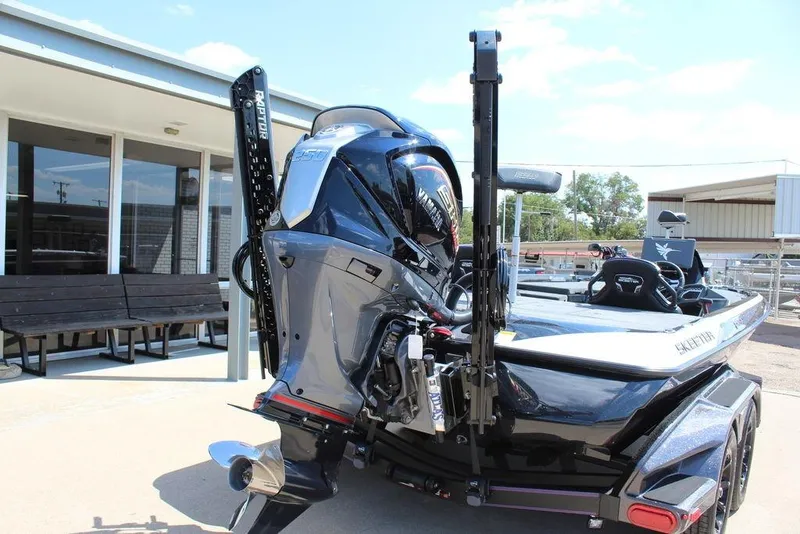 Slide: The Image of 2026 Skeeter FXR21 FLEX boat with Yamaha engine, parked outdoors. - 6