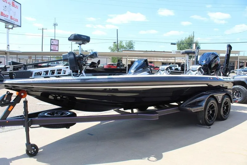 Slide: The Image of 2026 Skeeter FXR21 FLEX boat on trailer, displayed outdoors under clear sky. - 8